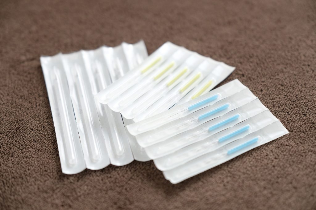 A collection of unopened acupuncture needles in a package